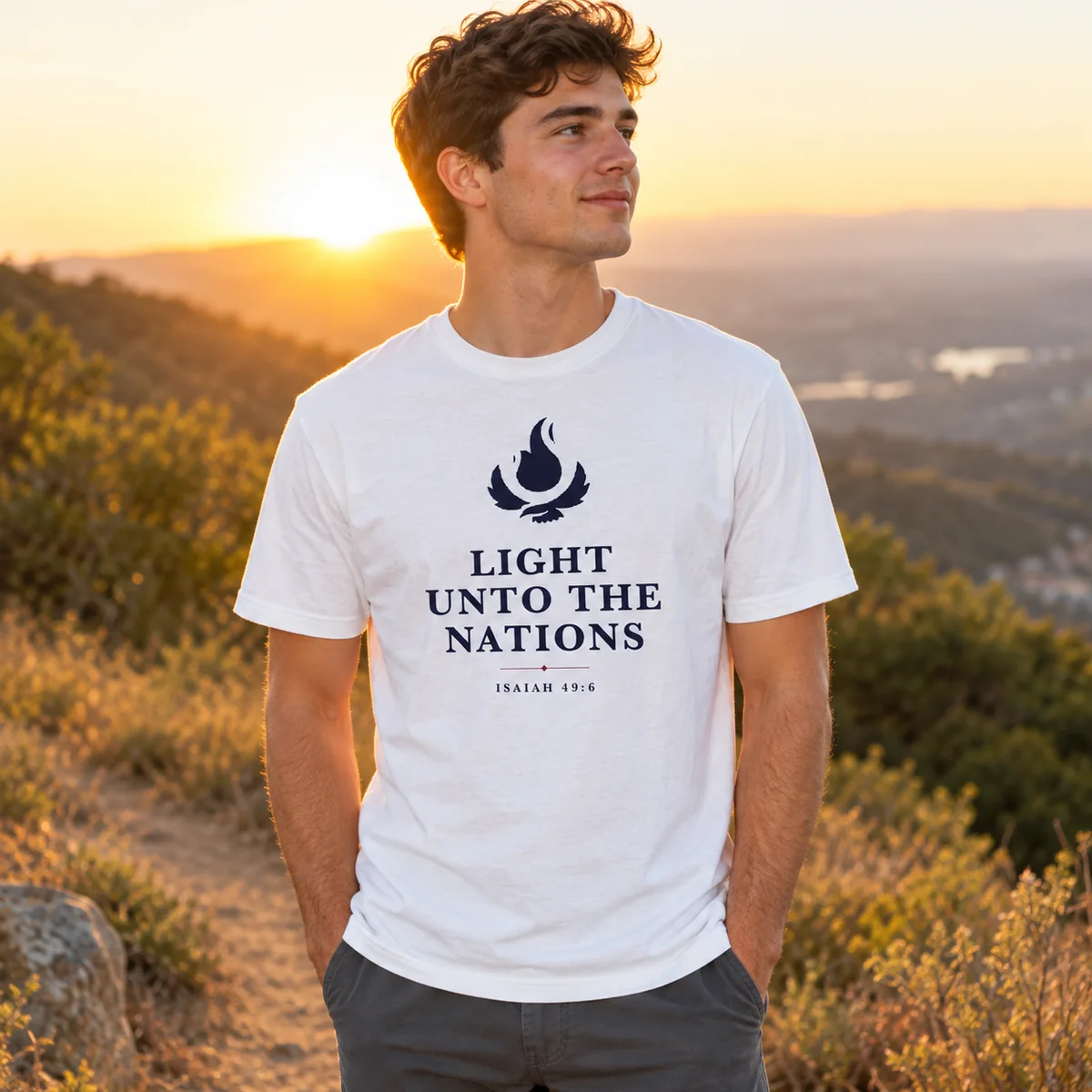 The Light Unto the Nations Tee in white, worn at sunset